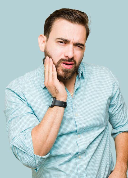 A man with a beard and a wristwatch, representing the meticulous nature of restorative dentistry.