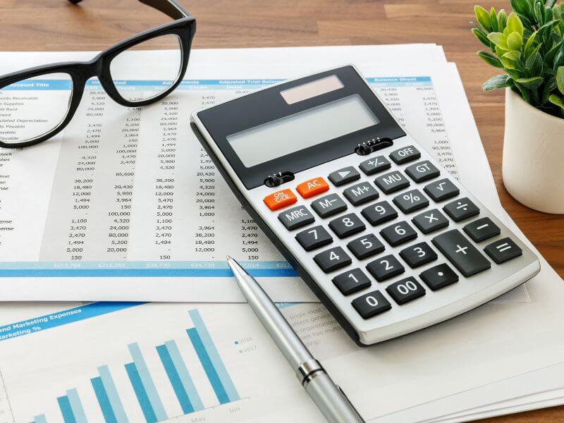 Calculator, glasses, and documents for financial planning