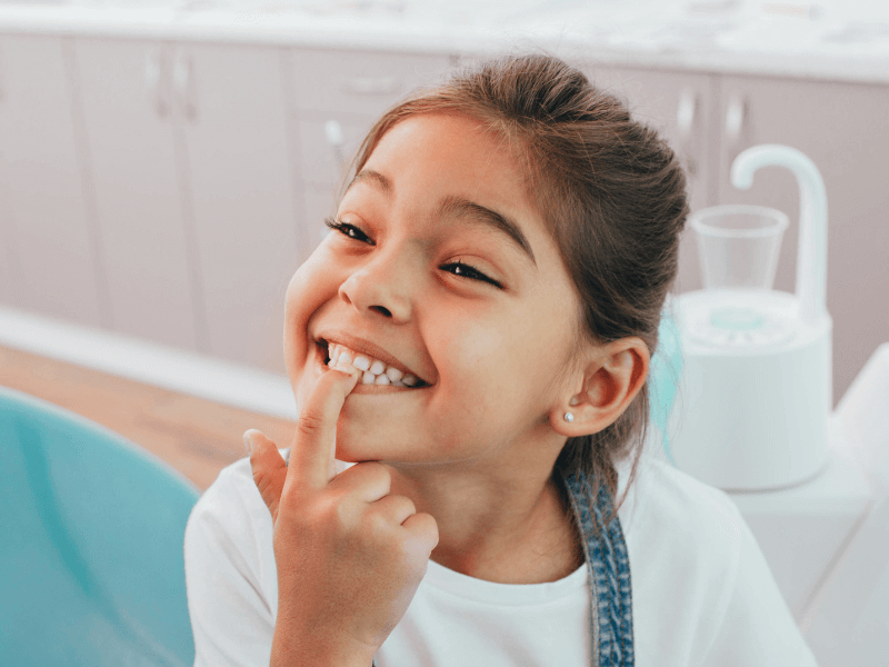 little patient showing her perfect toothy smile