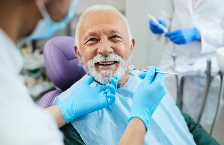 A cheerful man enjoys a dental cleaning