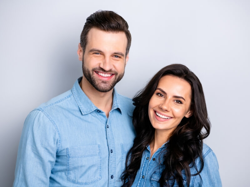 A man and woman are smiling joyfully