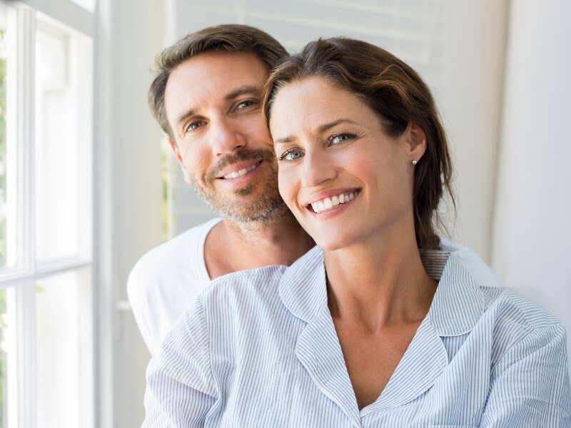 A man and woman smile joyfully together