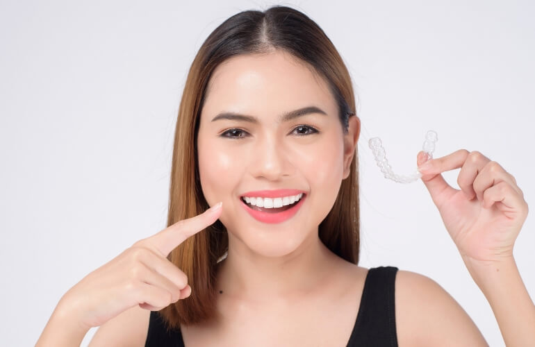 Patient smiling during retainer adjustment