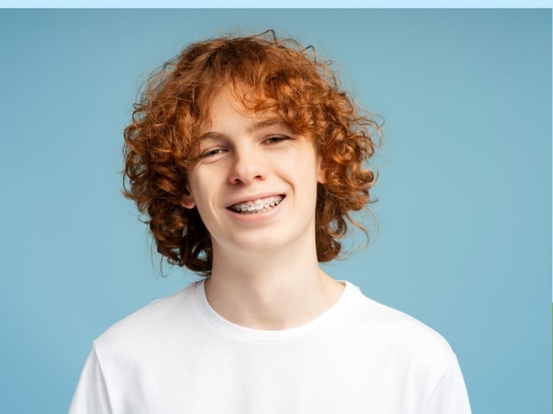 Portrait of a smiling redhead boy with curly hair