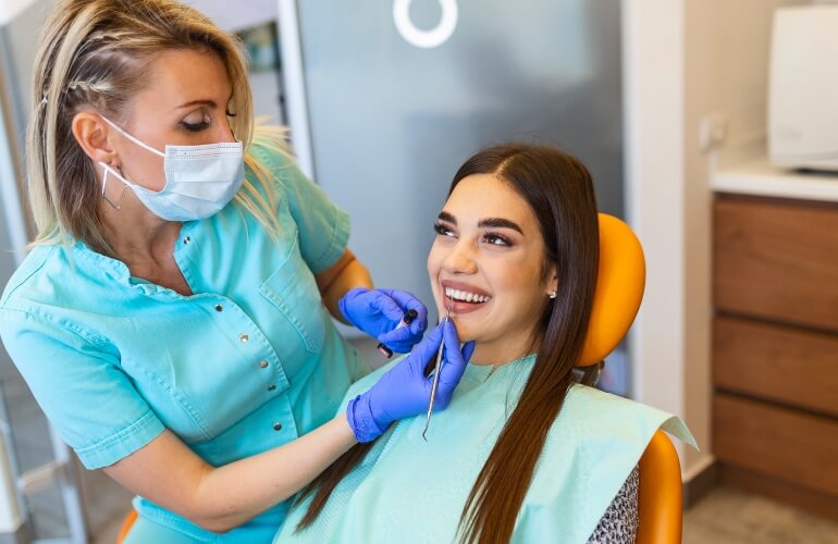 Dentist inspecting patient's teeth closely