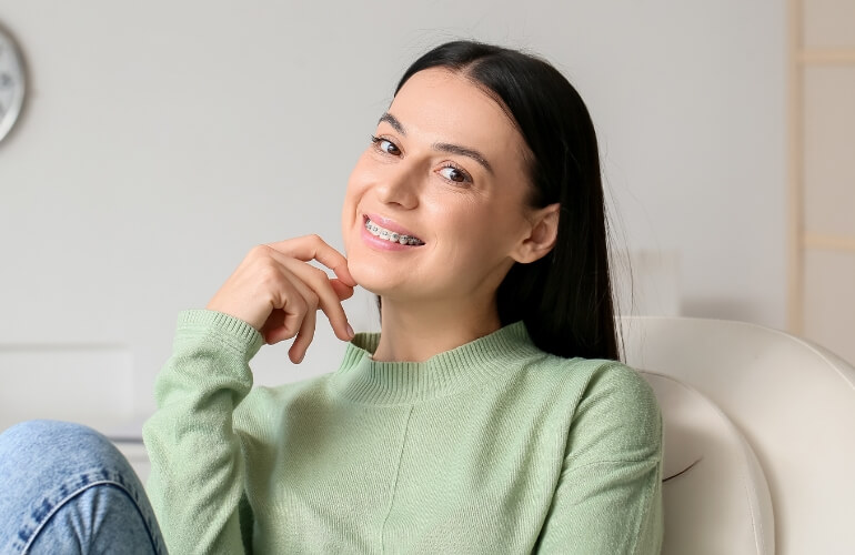 Girl smiling with metal braces.