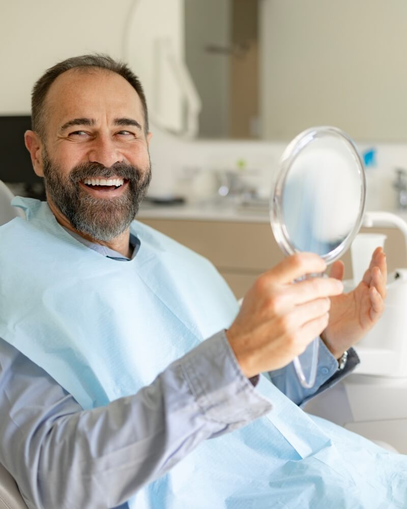 Happy man checking dental results