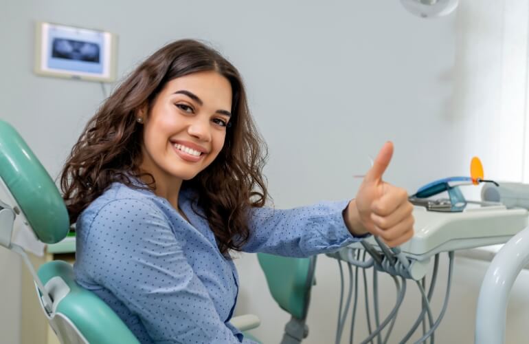 Happy patient thumbs up dentist