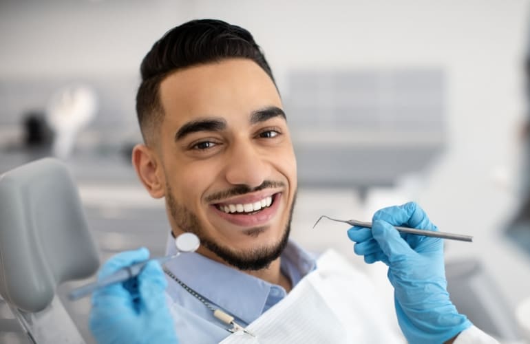 Dentist and assistant treating patient