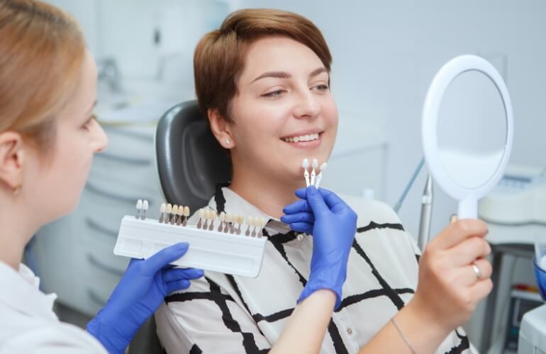 Smiling patient choosing tooth color