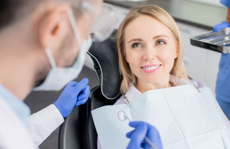 A dentist examines a patient in a modern dental office