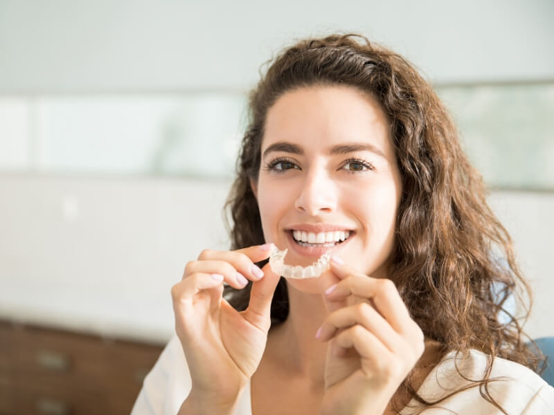 A woman smiles joyfully-mobile