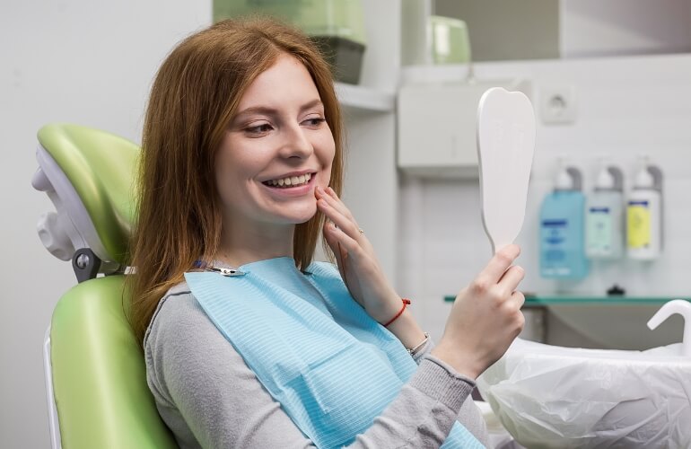 Dentist adjusting patient's dental braces