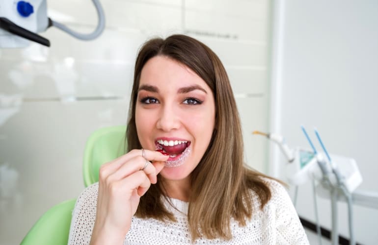 Smiling woman with dental retainer