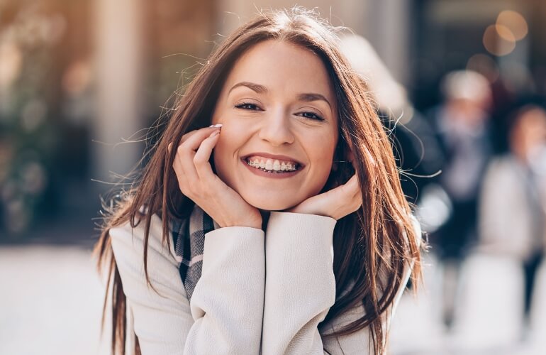 Woman smiling while wearing braces.