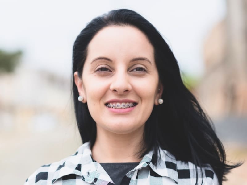 Women holding invisible aligners